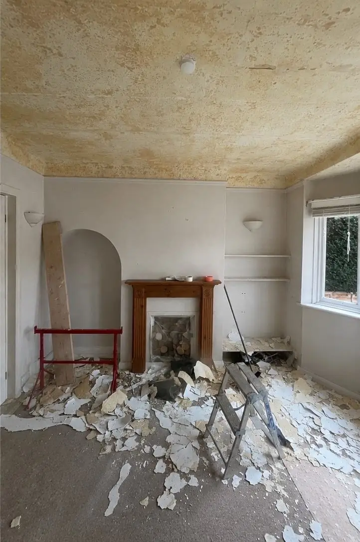 Fireplace wall with an arched alcove before work started