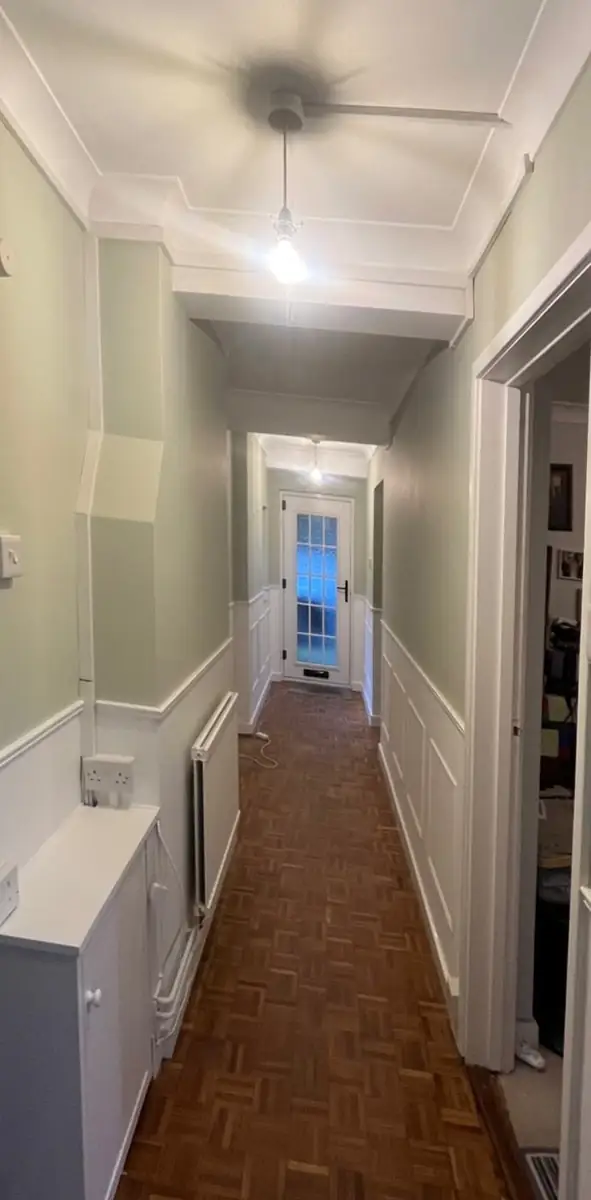 Long hallway after plastering and decorating