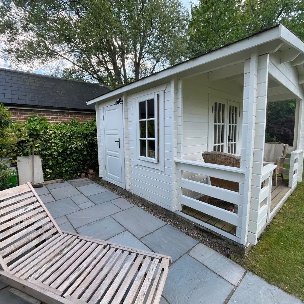 Painted timber summer house in a garden